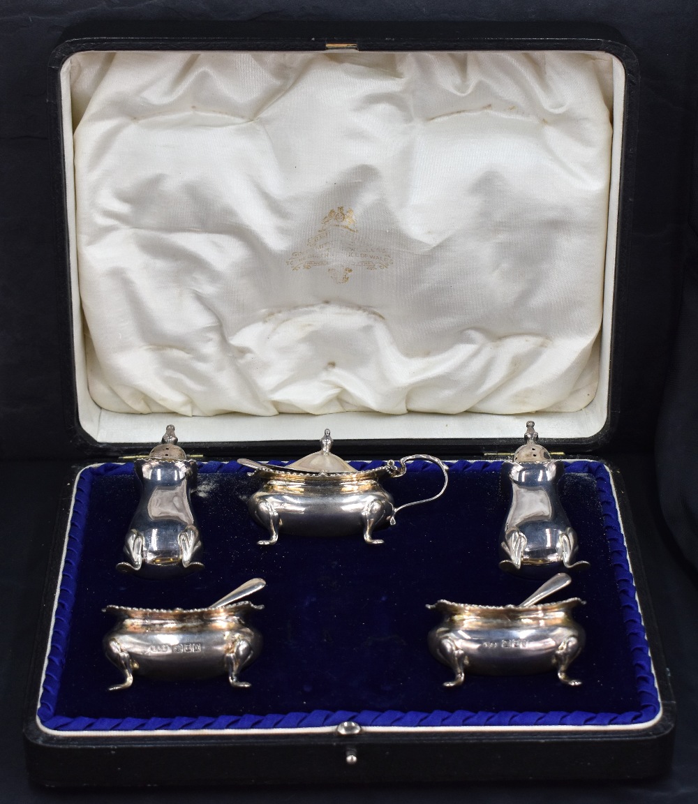 A George V cased silver condiment set, comprising salts, pepperettes and mustard and three condiment