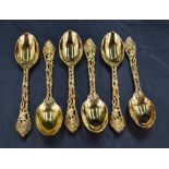 A set of six Queen Elizabeth II silver gilt tea spoons, having oval bowls, cast and pierced fruiting