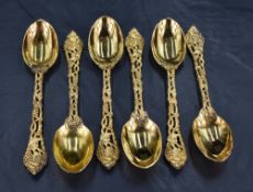A set of six Queen Elizabeth II silver gilt tea spoons, having oval bowls, cast and pierced fruiting