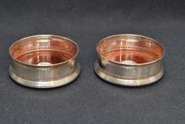 A pair of Queen Elizabeth II silver and mahogany wine coasters, of traditional design with bands