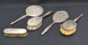 A George VI silver mounted three-piece dressing table set, comprising hand mirror, hair brush and