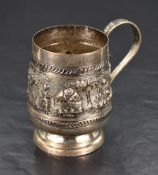 A Burmese white metal cup, of slightly spreading cylindrical form decorated with an embossed and