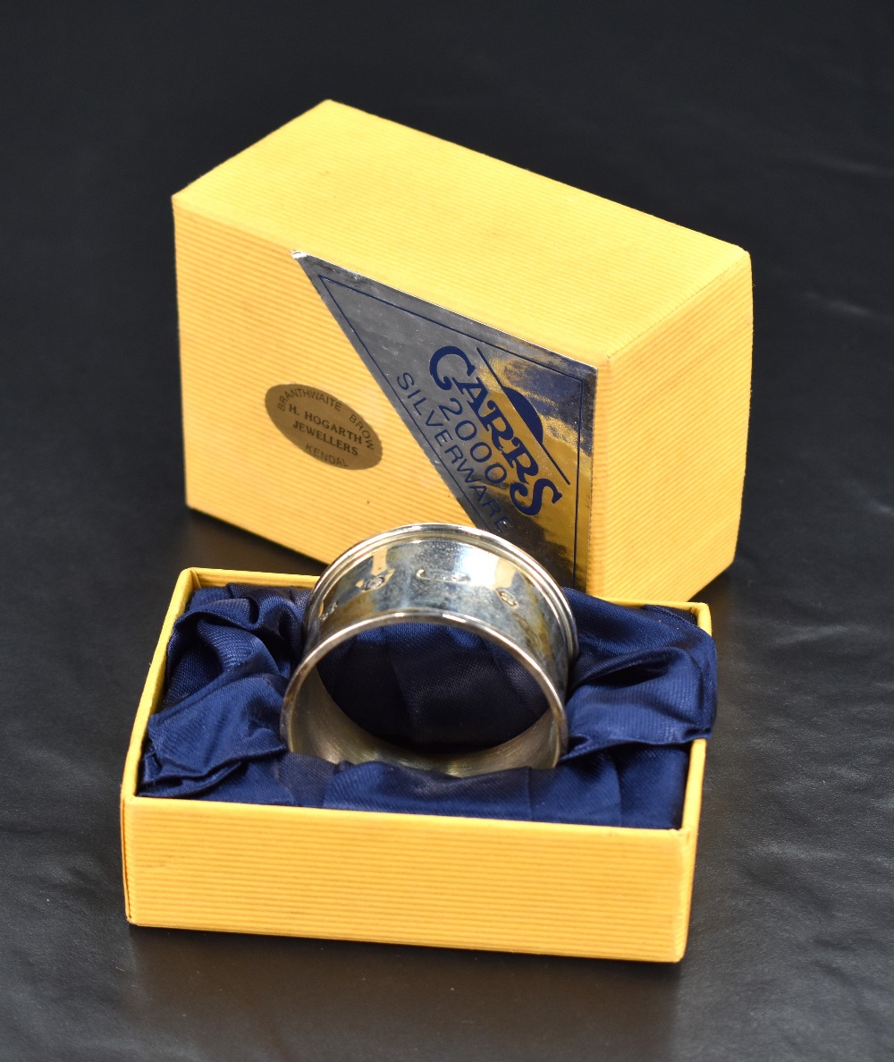 A Queen Elizabeth II 'Millennium' silver napkin ring, of collared cylindrical form with marks for