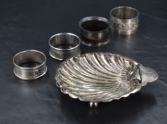 A George V silver scallop shell form butter dish, with engraved deer or antelope crest, and three
