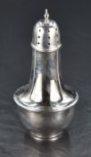 A George V silver and bakelite sugar caster, of traditional form with pull-off pierced cover, the