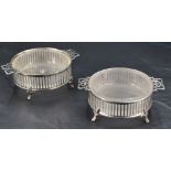 A pair of George V silver and frosted glass table salts, of circular form with pierced strapwork