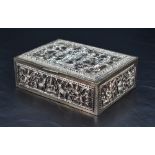 A Burmese white metal and brass box, of hinged rectangular form, decorated with panels of