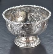 A Victorian silver bowl, of circular form and embossed with foliage and scrolls, engraved with