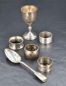 A selection of mixed silver, to include four napkin rings, George III fiddle pattern spoon and small