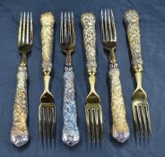 A set of six Queen Elizabeth II silver gilt dessert forks, having four tapering tines, cast fruiting