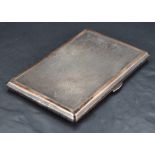 An early Queen Elizabeth II silver cigarette case, of piano hinged rectangular form with engine-