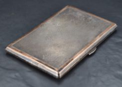 An early Queen Elizabeth II silver cigarette case, of piano hinged rectangular form with engine-