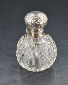 An Edwardian silver topped cut-glass scent bottle, of typical globular form cut with overlapping