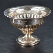 An Edwardian silver bowl, of ogee fluted form with flared rim and moulded circular foot, engraved