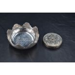 A French white metal Jean Puiforcat dish, of circular form with arcaded rim, the interior with