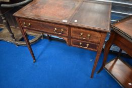 An Edwardian mahogany desk having lift top to reveal stationery compartment and leather skiver
