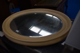 A vintage oval wall mirror