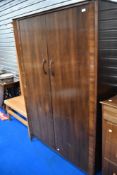 A vintage sapele two piece bedroom suite by Waring and Gillows