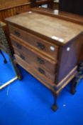 An early 20th Century three drawer chest on stand in the Queen Anne style