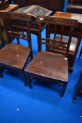 A pair of 19th Century mahogany rail back hall or dining chairs having rail and bobbin backs