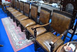 A set of eight (six plus two) oak framed dining chairs having Carved vine detailing and leather