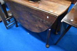 A late 19th or early 20th Century oak gateleg table having cabriole legs