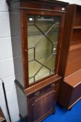 A reproduction Regency style narrow display cabinet with drawer and cupboard under