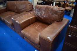 A modern brown leather settee and chair