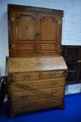 A 19th Century golden oak bureau bookcase having inlaid shell and moth designs , brass hinges to