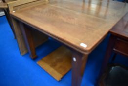 A late 19th or early 20th Century oak windout dining table with additional leaf