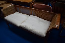 A traditional teak framed French style day bed having canework panels, seat width approx. 150cm