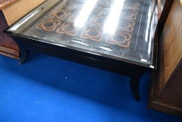 A quality modern coffee table having celtic style motif and glass top, approx. 130 x 130cm