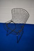 A vintage Harry Bertoia wire framed dining chair in black finish with red leather seat pad
