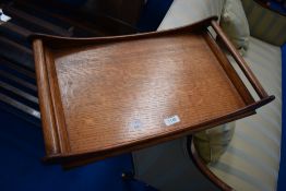 A golden oak tray in the Arts and Crafts style, believed to be Arthur Simpson Handicrafts