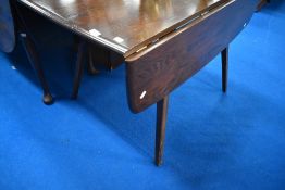 A dark stained Ercol drop leaf dining table