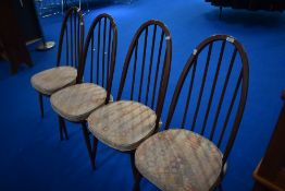 A set of four tradtional dark stained Ercol high hoop and stick back kitchen dining chairs
