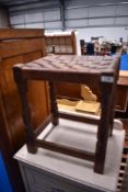 An Arts and Crafts leather lattice top stool, having adzed frame, similar in style to Mouseman but
