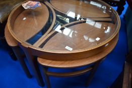 A vintage teak glass top coffee table with three stylised occasional tables beneath
