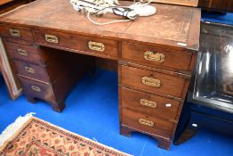 A campaign style pedestal desk