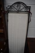A metal and canvas three panel modesty screen