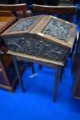 A late 19th or early 20th Century oak sewing box having foliate applique decoration