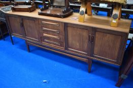 A vintage G Plan teak sideboard, central bank of four drawers flanked by double cupboard, width
