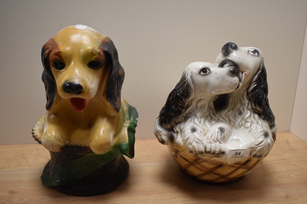 Two vintage chalkware carnival dog ornaments, the largest measures 29cm tall