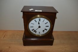 An Edwardian mahogany mantel clock, by Camerer, Cuss & Co., the enamelled dial having roman numerals