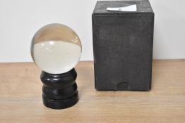 A vintage crystal ball with stand and box.