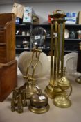 A Victorian brass rotating desk magnifying glass, a brass pricket stand, an incense burner, plus