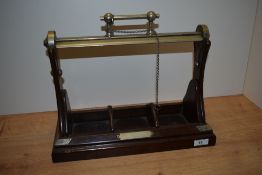 An early 20th Century oak tantalus, with three divisions, and white metal mounts, measuring 30cm x