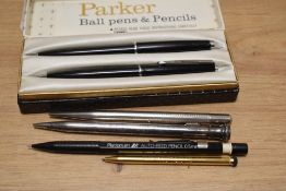 A Boxed Parker 45 ballpoint pen and propelling pencil set in black and four propelling pencils