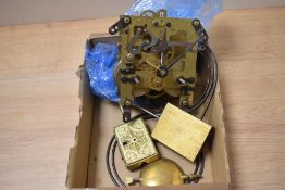 A box of brass clock workings, including a Gustav Becker clock mechanism