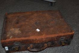 An early 20th Century leather suitcase with lined interior, 51cm long